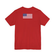 Back of a red t-shirt with an American flag on the back against a white background
