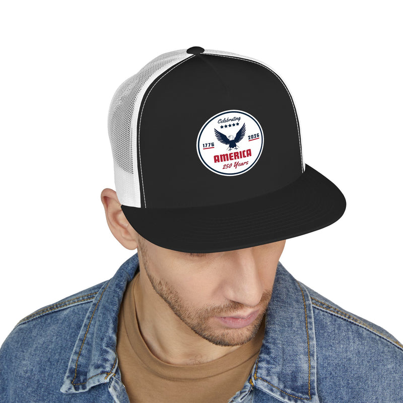 Man wearing a black and white flat bill trucker cap with a logo 'celebrating America 250 years' on a white background.