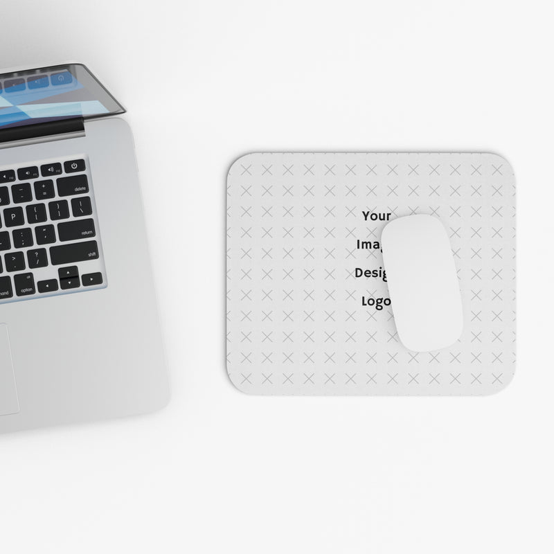 Customizable white mouse pad with "your image or design" placeholder next to a laptop on a white background. 