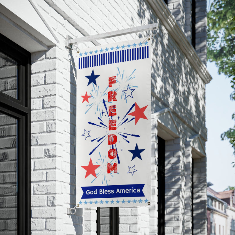 Patriotic vinyl banner with red white and blue stars, fireworks and the word freedom 24x48 and 36x72 inches hanging on a building.