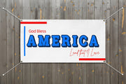 Patriotic “God Bless America” horizontal vinyl banner with blue stripes and red and blue stars, 72x36 and 48x24 inches on a wood fence.